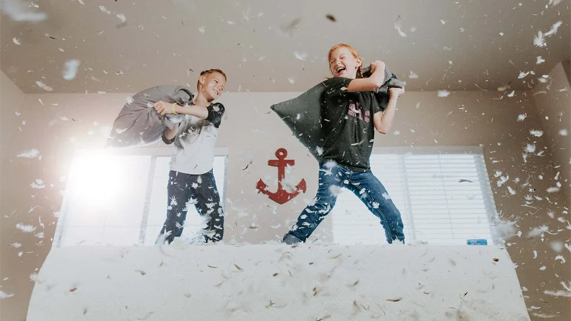 kids playing with feather/ down pillows