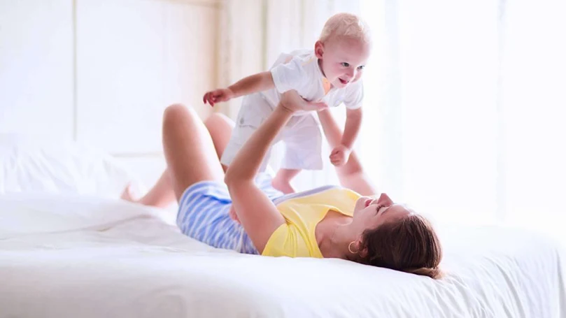 an image of a mom playing with her baby