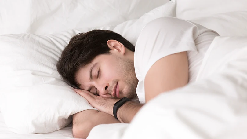 uma imagem de um homem a dormir bem após a hipnose do sono