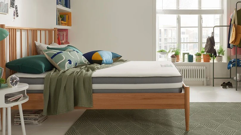 an image of silentnight studio eco hybrid mattress in a bedroom on a bed frame