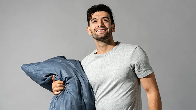 A happy young man due to healthy sleep hygiene.