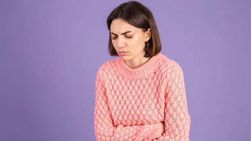 An image of a woman suffering from nausea.