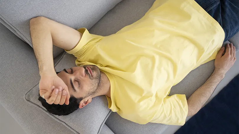 Uma imagem de um homem com uma camisa amarela a dormir sem ressonar