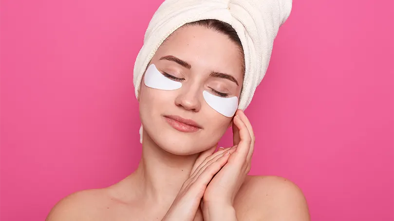 An image of a woman having rose eye mask.