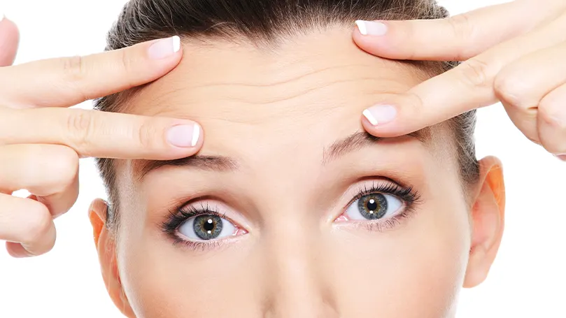 An image of a woman with wrinkles on her forehead.