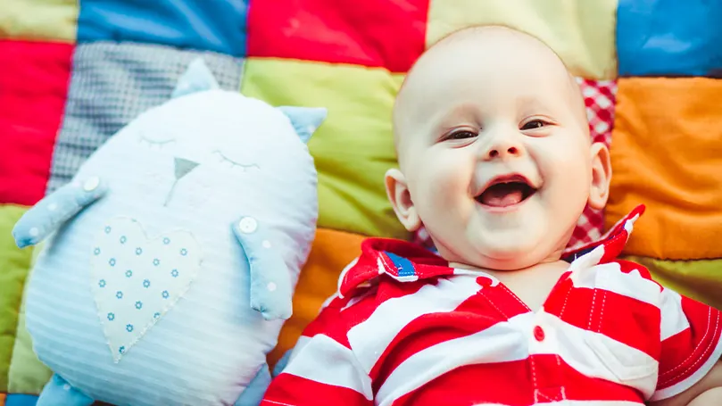 An image of a baby laughing.