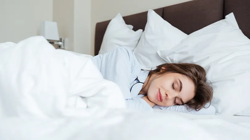 An image of a woman sleeping on Smartgrid mattress.