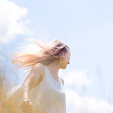 An image of a woman standing outside.