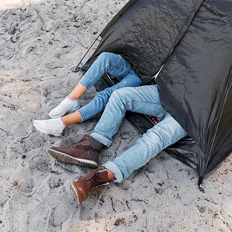 An image of a couple sleeping in a tent.