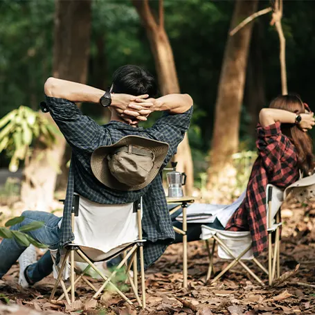 Uma imagem de um casal a desfrutar da sua viagem de campismo.