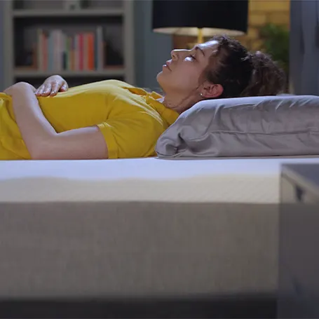 Person lying on the Hypnia Essential Hybrid Mattress as a back sleeper.